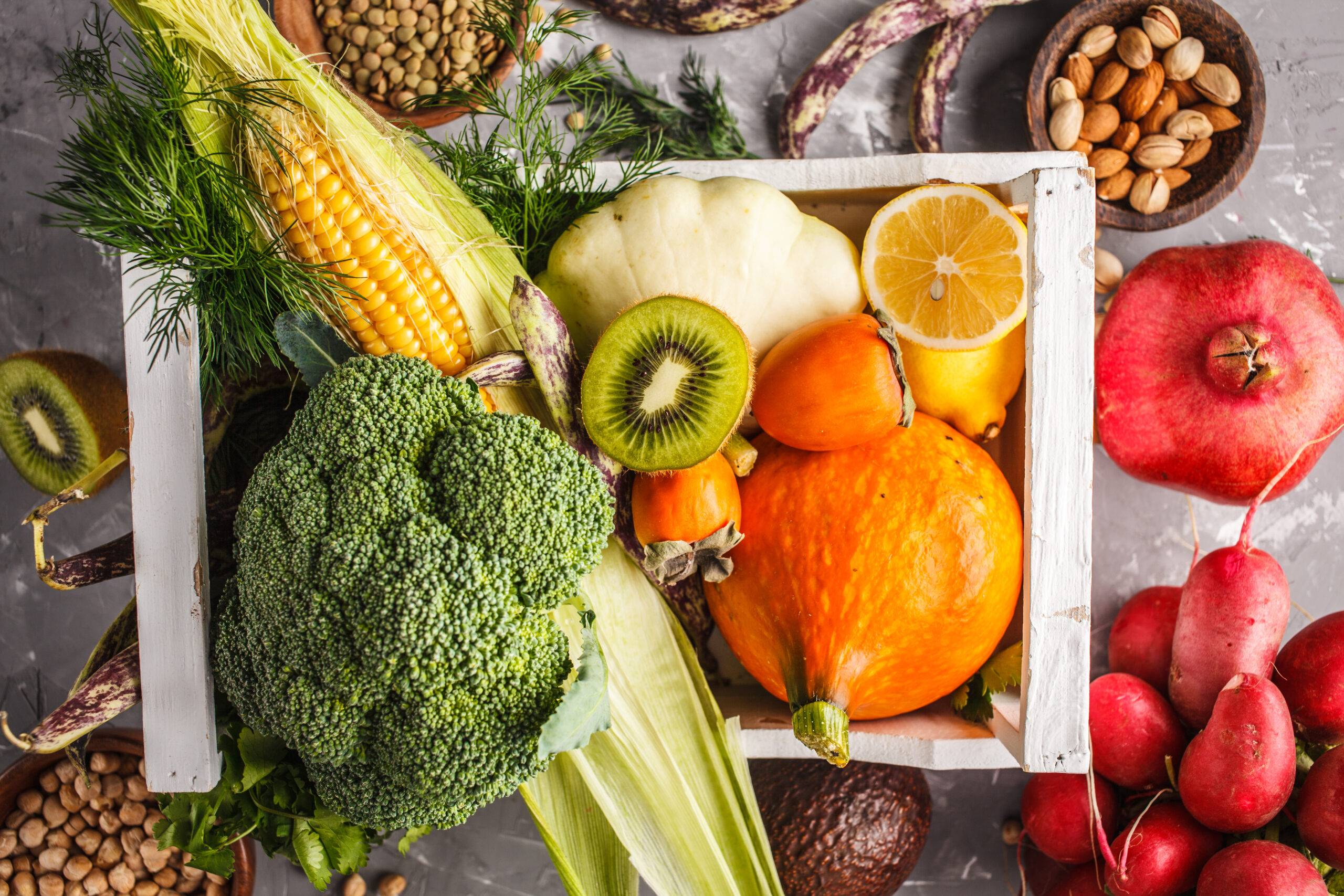 Fruits, vegetables and cereals in a wooden box, top view, health